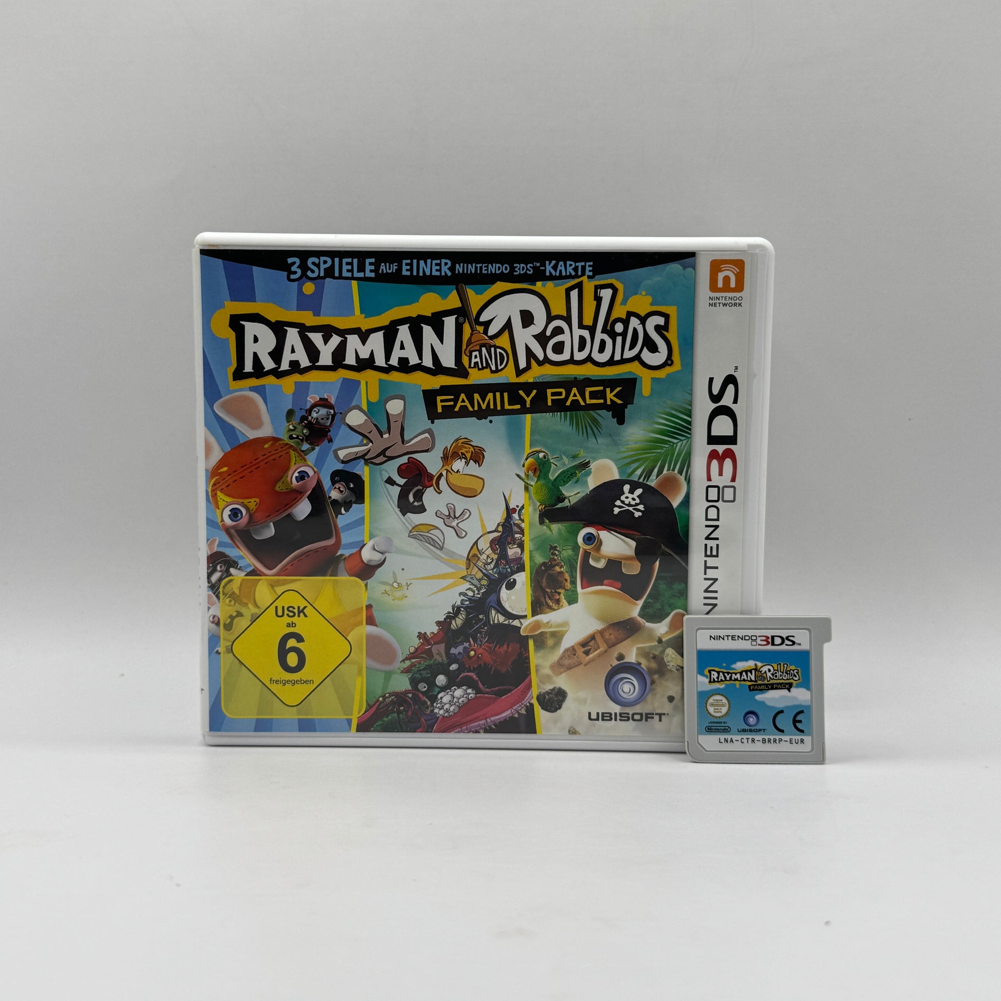Verpackung des Nintendo 3DS-Spiels Rayman & Rabbids: Family Pack, ein Party- und Minispiel-Spiel, in dem Spieler in humorvollen Levels als Rayman oder Rabbids verschiedene Herausforderungen meistern.