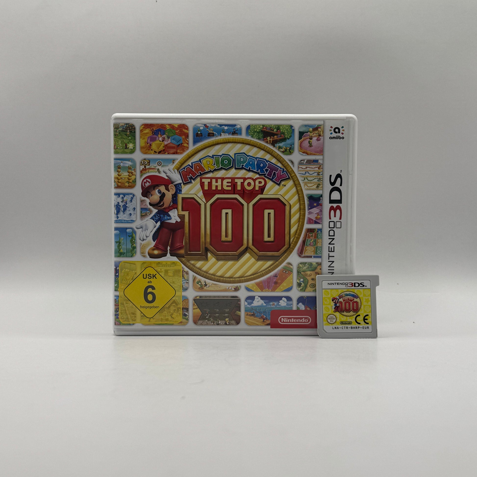 Verpackung des Nintendo 3DS-Spiels Mario Party: The Top 100, ein Partyspiel mit einer Sammlung der 100 beliebtesten Minispiele aus der Mario-Party-Reihe, spielbar allein oder im Mehrspielermodus.