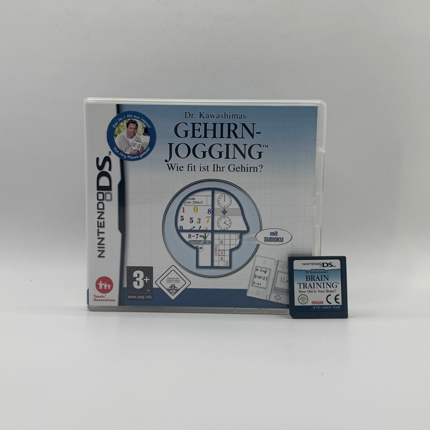 Verpackung des Nintendo DS-Spiels Dr. Kawashimas Gehirn-Jogging, ein Denk- und Trainingsspiel mit täglichen Übungen zur Förderung von Gedächtnis, Konzentration und Reaktionsfähigkeit.