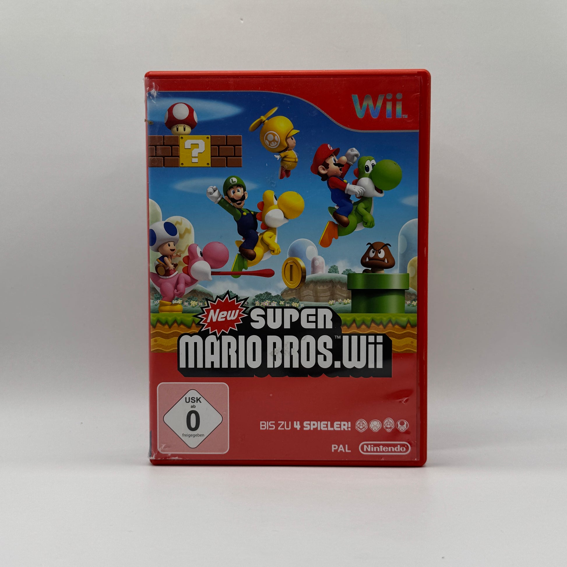 Verpackung des Wii-Spiels New Super Mario Bros. Wii, ein klassisches 2D-Jump’n’Run mit Mario, Luigi und Freunden, spielbar allein oder im Mehrspieler-Modus.