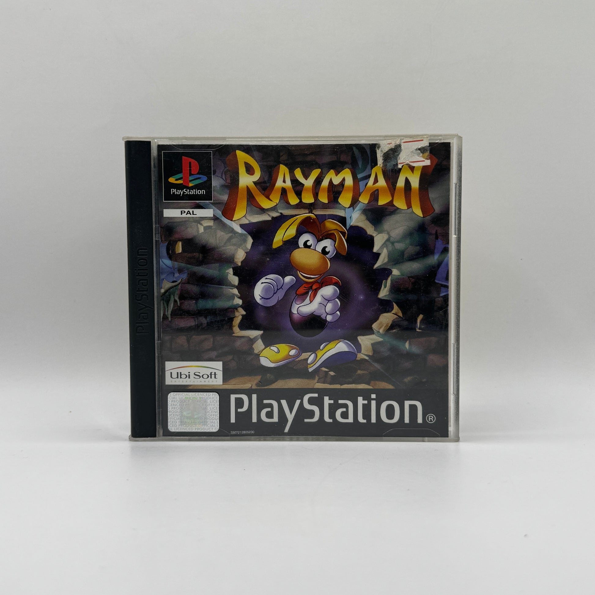 Verpackung des PS1-Spiels Rayman, ein 2D-Jump’n’Run, in dem Spieler die Figur Rayman durch farbenfrohe Level steuern, Gegner besiegen und Rätsel lösen.
