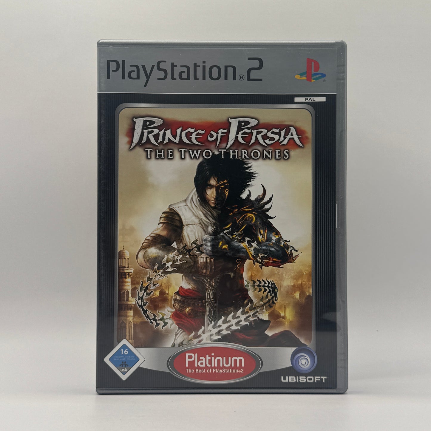 Verpackung des PS2-Spiels Prince of Persia: The Two Thrones, ein Action-Adventure, in dem der Prinz akrobatische Kämpfe bestreitet, Zeitmanipulation nutzt und Babylon von Feinden befreit.