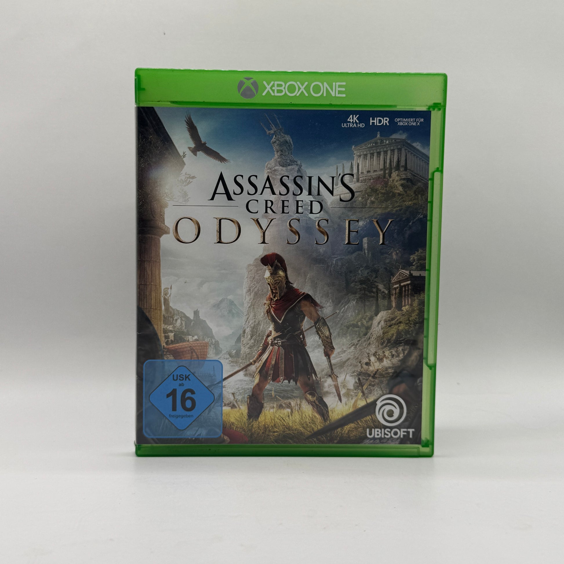 Verpackung des Xbox-One-Spiels Assassin’s Creed Odyssey, ein Action-Rollenspiel, in dem Spieler im antiken Griechenland eine offene Welt erkunden, Quests erfüllen und epische Kämpfe bestreiten.
