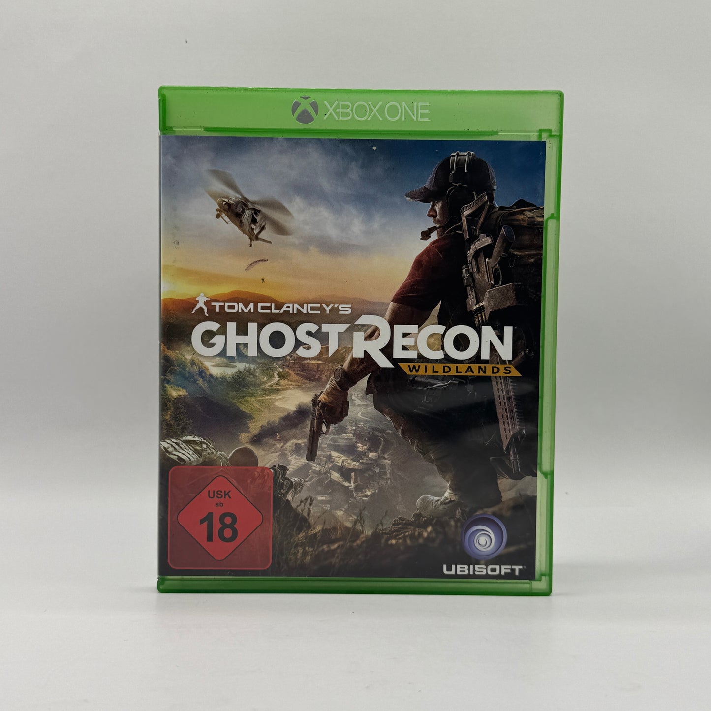 erpackung des Xbox-One-Spiels Tom Clancy’s Ghost Recon: Wildlands, ein Open-World-Taktik-Shooter, in dem Spieler als Elite-Spezialeinheit Missionen in einer offenen Welt absolvieren, allein oder im Koop.