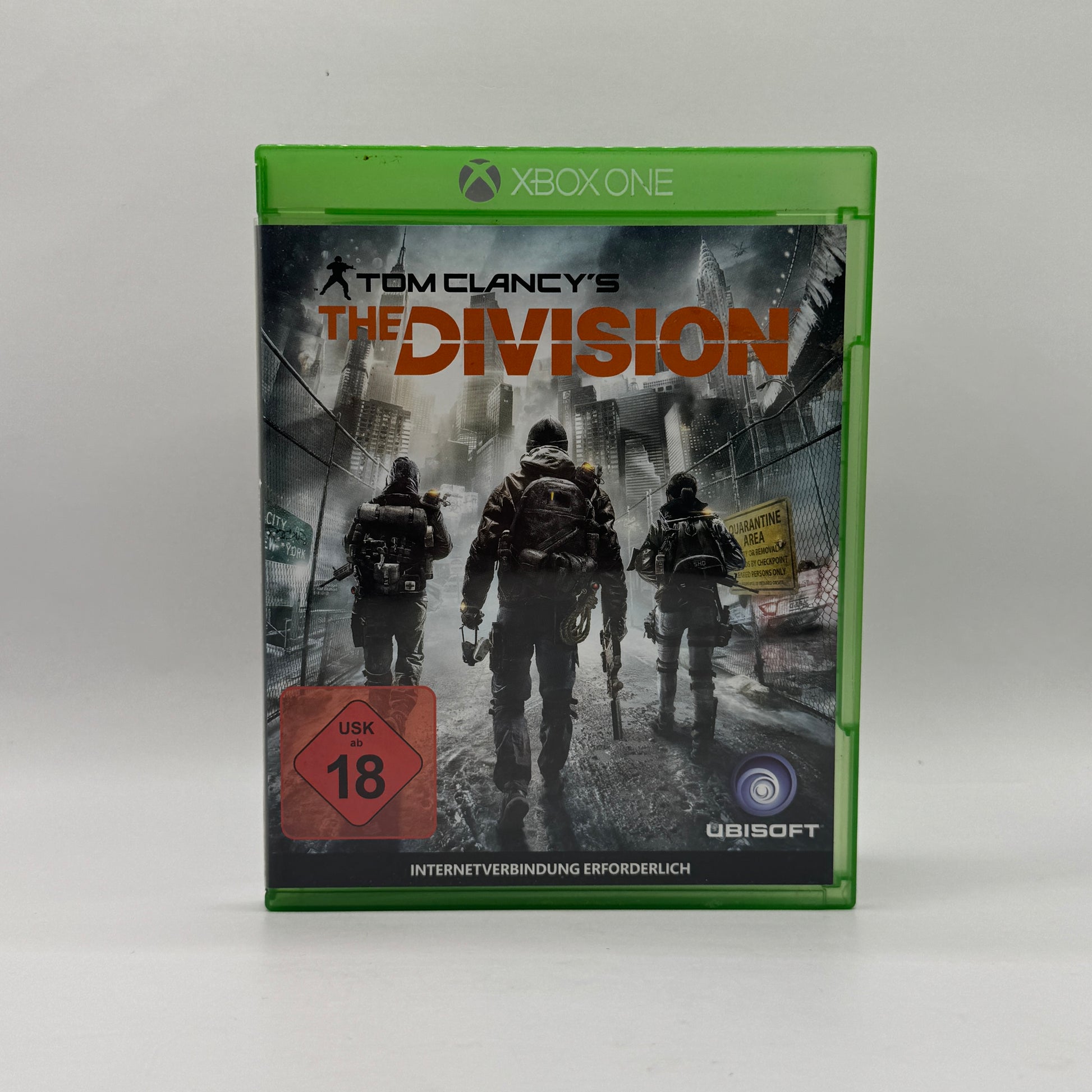Verpackung des Xbox-One-Spiels Tom Clancy’s The Division, ein Online-Action-Rollenspiel und Taktik-Shooter, in dem Spieler als Agenten New York City nach einer Pandemie erkunden und Missionen allein oder im Koop absolvieren.